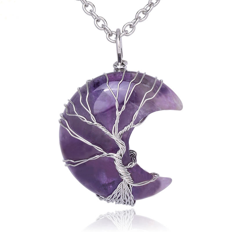 Purple crescent moon pendant with silver tree design on a white background