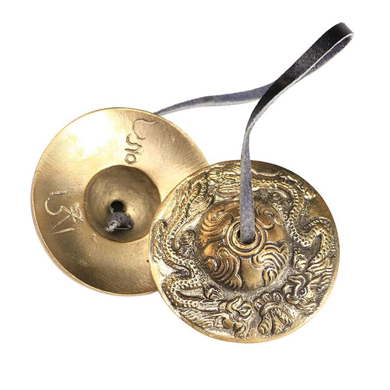 Brass incense burner with dragon design on a white background
