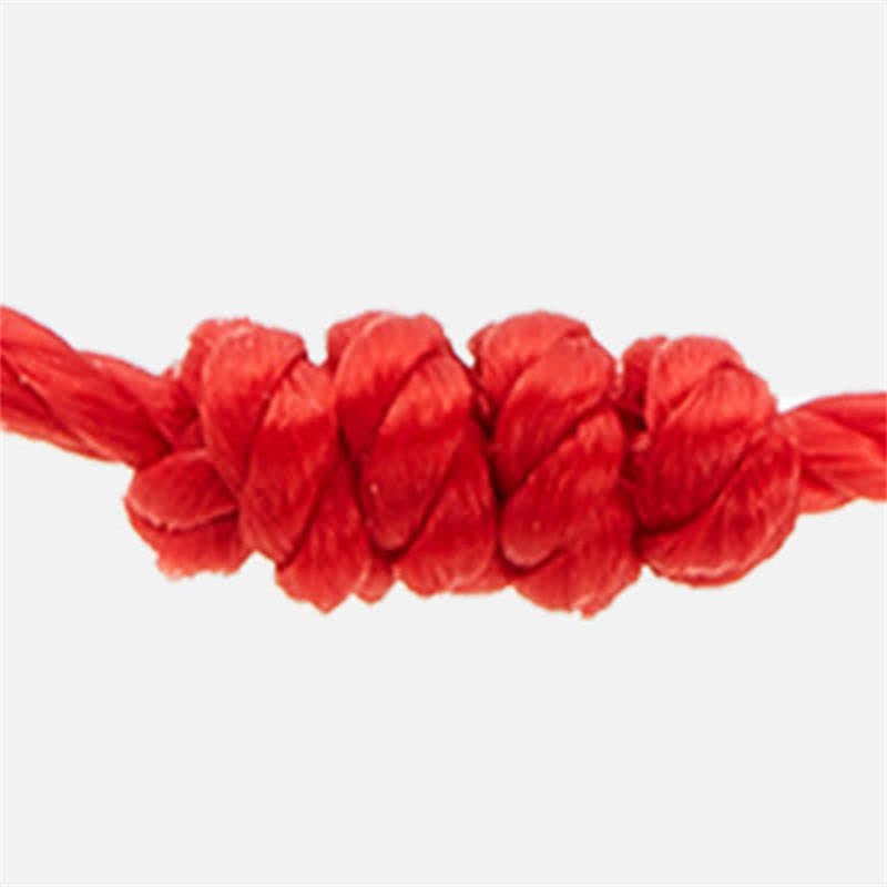 Close-up of a red rope with a knot on a white background