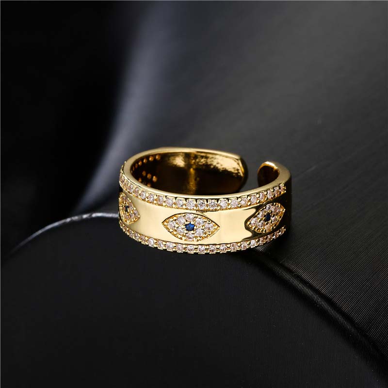 Gold ring with diamond accents on a black background
