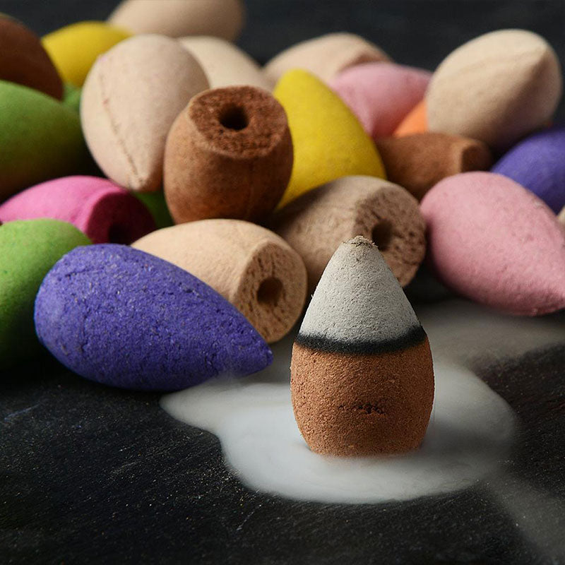 Colorful incense cones on a dark surface