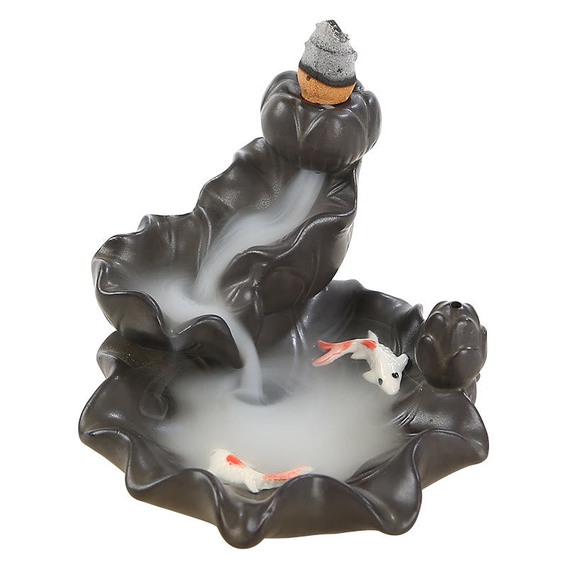 Backflow incense burner with incense sticks and fish design on a white background