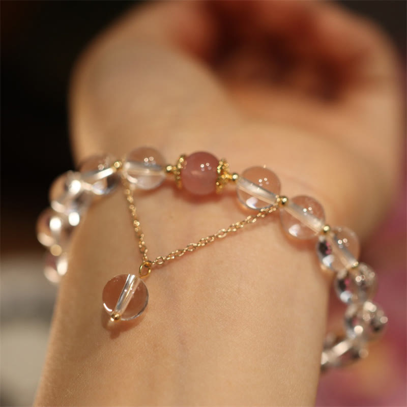 Bracelet with pink and clear beads on a wrist against a blurred background