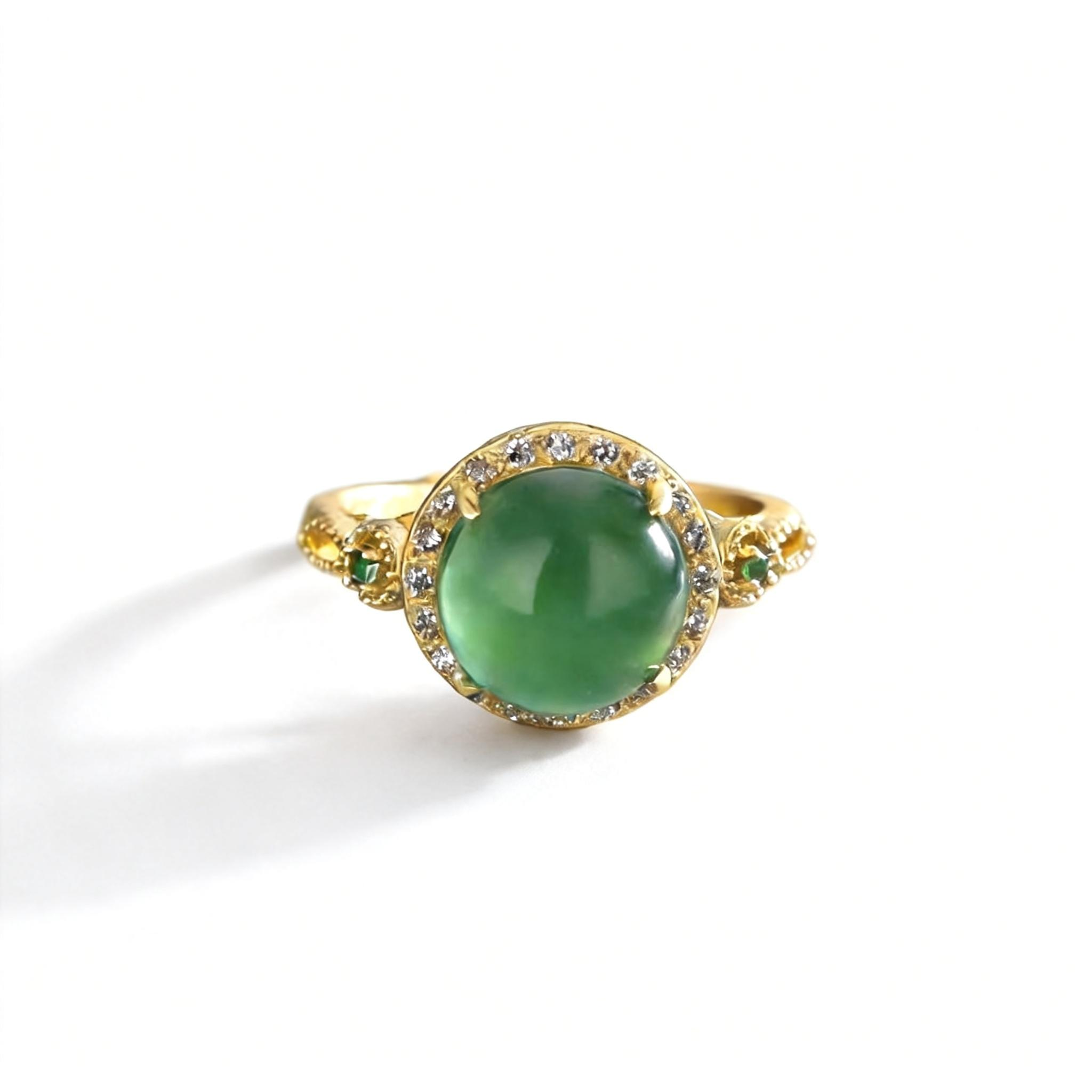 Gold ring with a green gemstone on a white background
