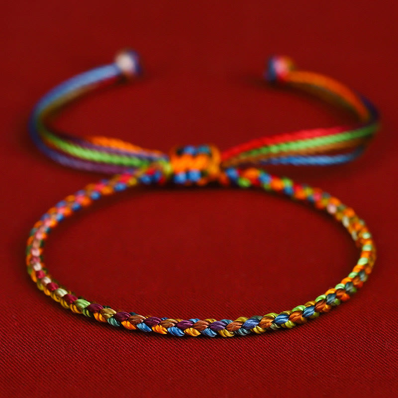 Colorful braided bracelet on a red background