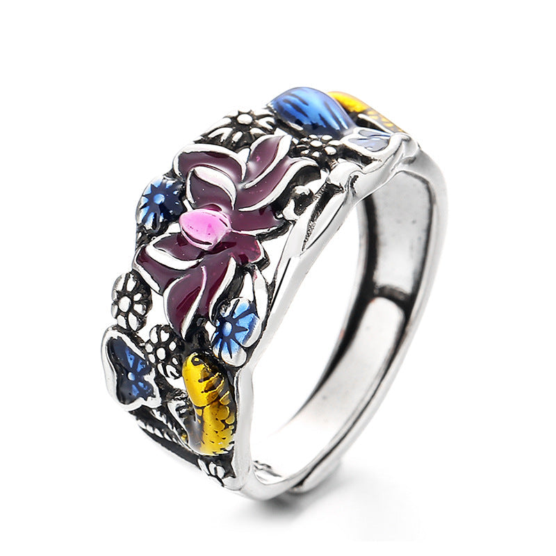 Decorative ring with floral and butterfly design on a white background