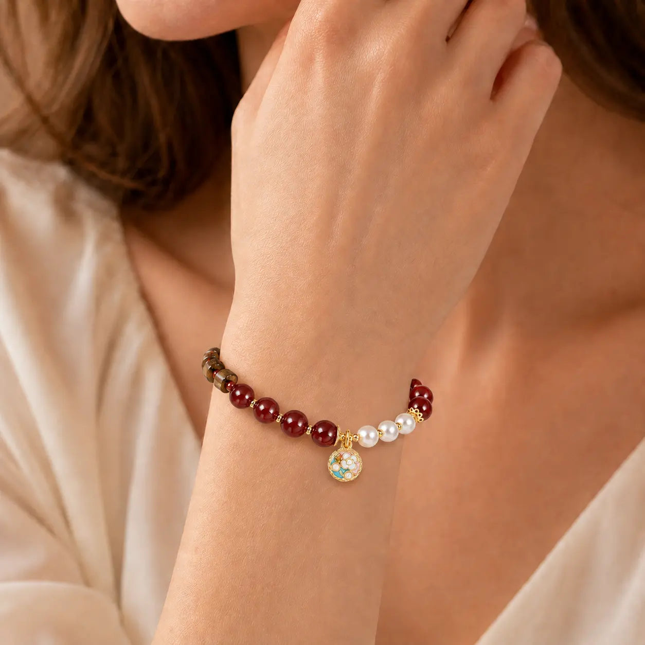 Sandalwood Pearl Agate Beaded Bracelet worn on wrist with floral charm