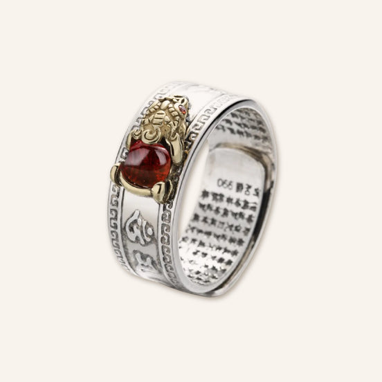 Guarded Wealth Red Agate Pixiu Ring featuring a silver-tone band, red agate stone, and detailed gold-tone Pixiu accent in a clean product image.