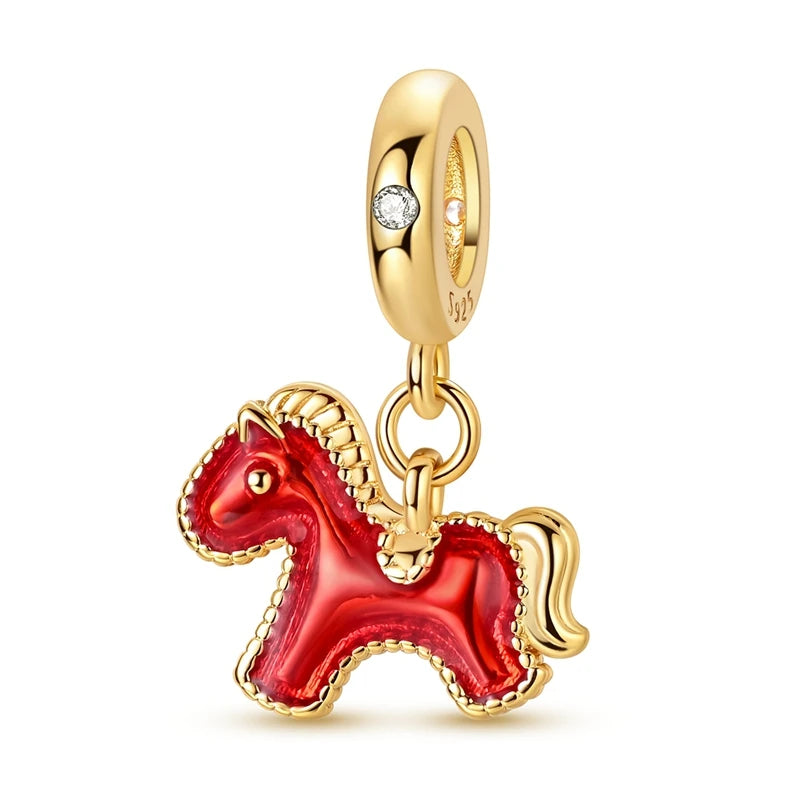Gold and red horse-shaped charm on a white background