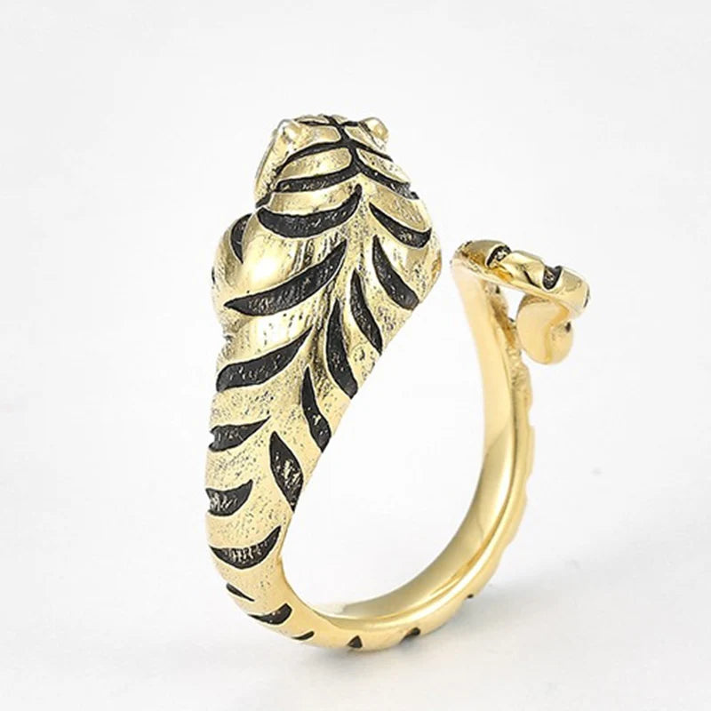 Gold and black feather-shaped earring on a white background