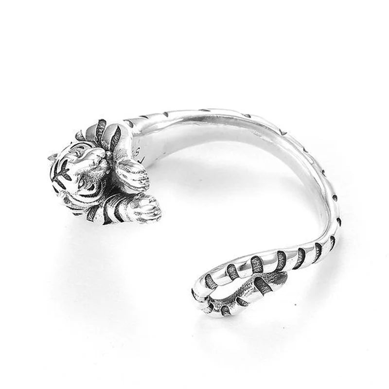 Silver ring with a detailed design on a white background