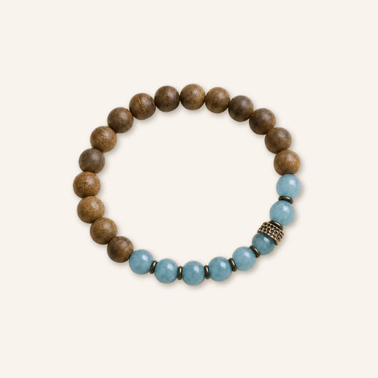 Soft Flow Agarwood Blue Chalcedony Bracelet with aged agarwood beads, blue chalcedony accents, and antique copper spacer on a warm neutral background.