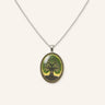 Vintage Tree of Life Necklace featuring a silver-tone chain, oval Tree of Life pendant, green leaf details, and vintage-inspired botanical artwork in a clean product image.