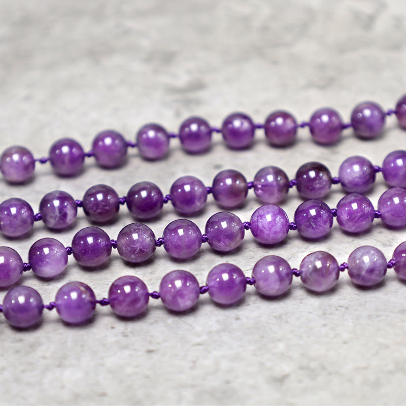 Purple beaded necklace on a light gray background