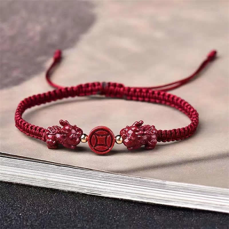 Red bracelet with decorative elements on a textured surface