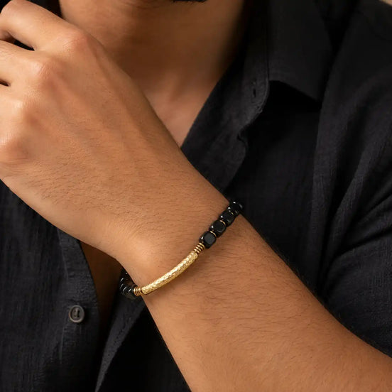 Black obsidian brass pipe bracelet worn on the wrist