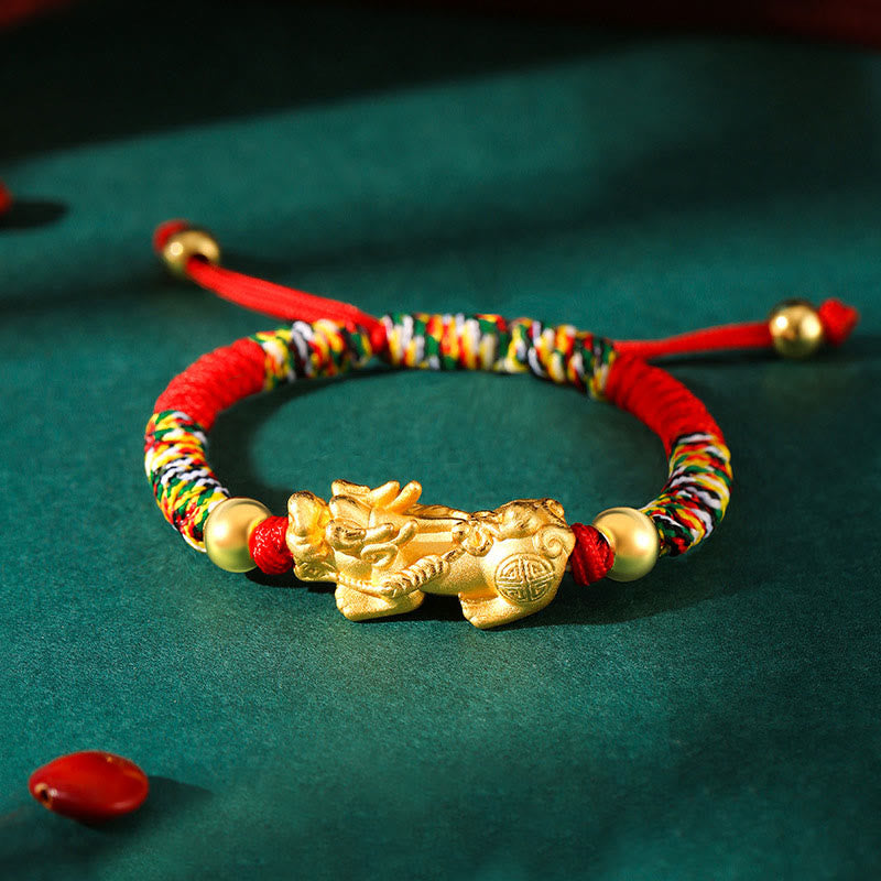 Colorful beaded bracelet with a gold dragon charm on a green background