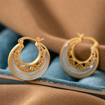 Pair of Crescent Moon Jade Earrings showing smooth jade texture and refined gold details | TheFuMaster