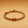 Colorful braided bracelet on a beige background