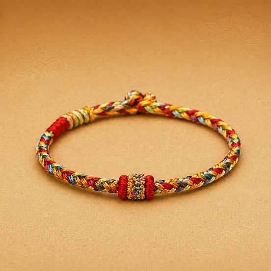 Colorful braided bracelet on a beige background