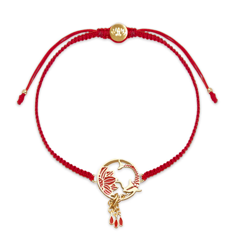 Red bracelet with gold charms on a white background