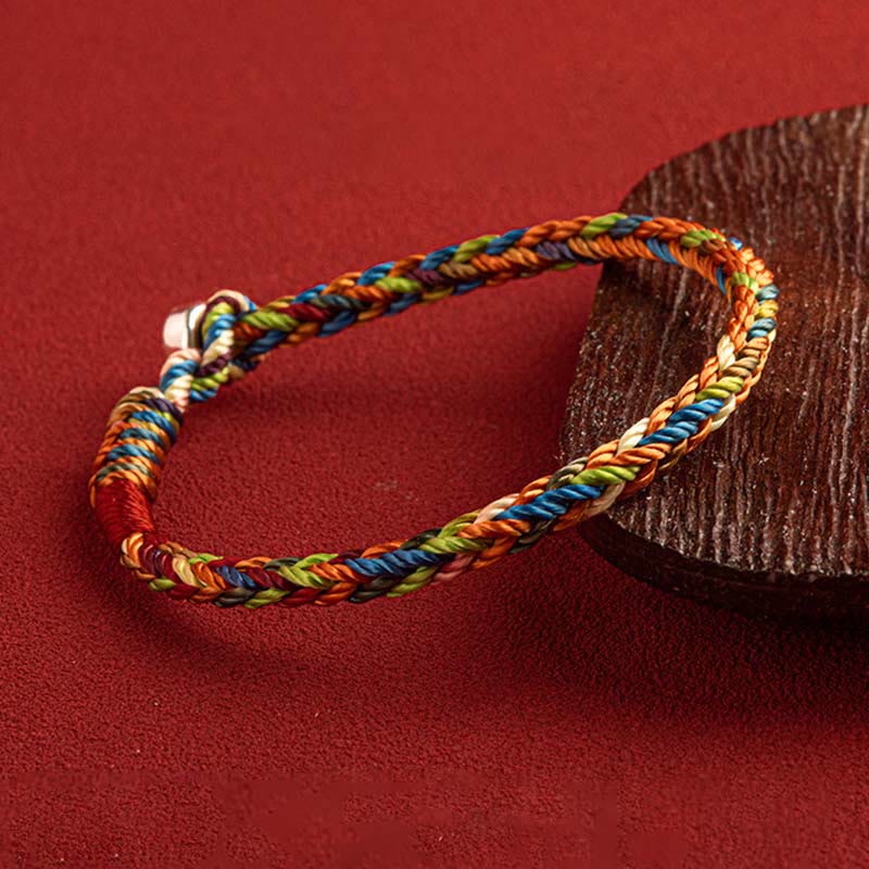 Close-up of the Five-Color Longevity Blessing Bracelet – vibrant threads interwoven for protection and balance.
