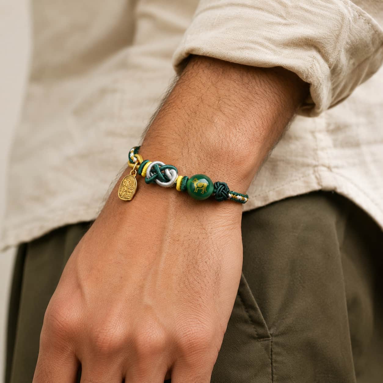Five Elements Green Rope Zodiac Ox Tai Sui Bracelet alternate view showing green rope and gold-tone charm details by TheFuMaster