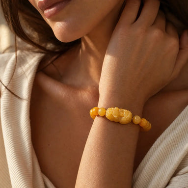 Golden pixiu jade bracelet worn on the wrist