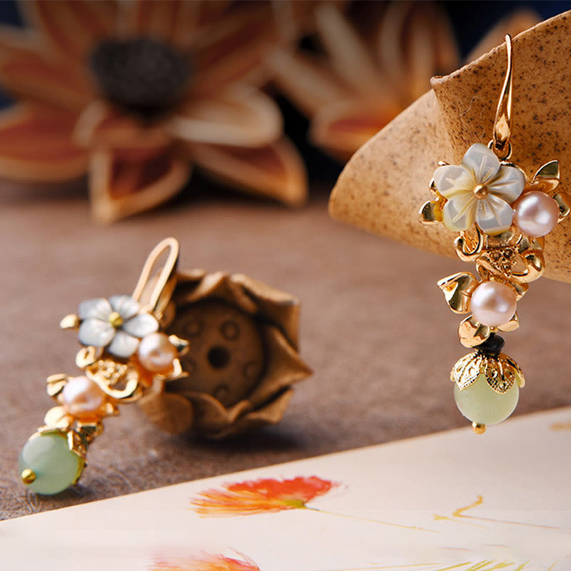 Side view of gray tridacna stone flower earrings with light green pearl drops – TheFuMaster