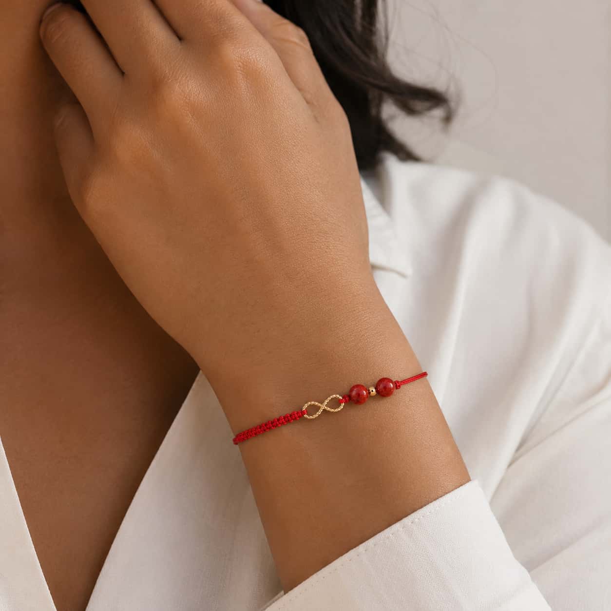 Close-up of Infinity Red String Bracelet with red string and cinnabar