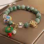 Jade Fu Charm Bracelet gift presentation with soft light and floral decoration – TheFuMaster