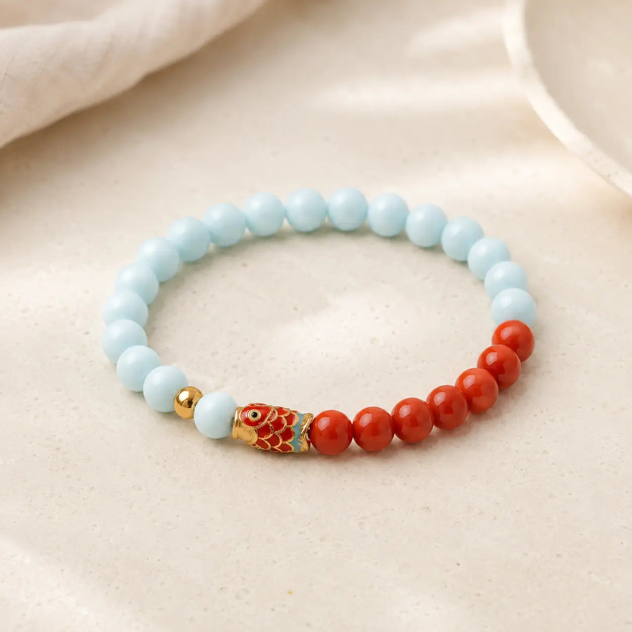 Koi Luck Turquoise & Cinnabar Bracelet shown from another angle with cinnabar and turquoise