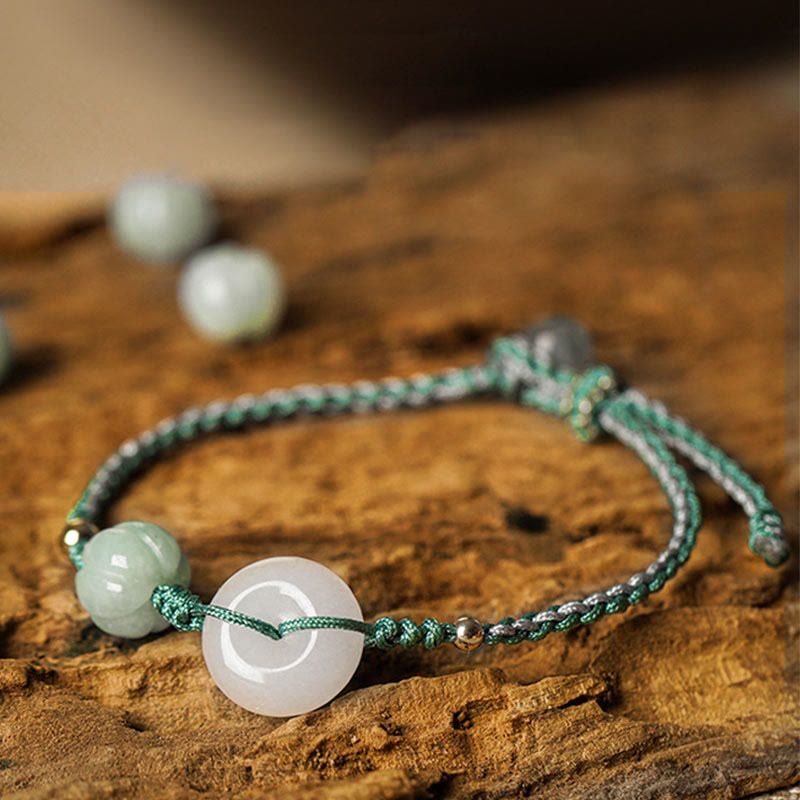 Bracelet with green and white beads on a wooden surface