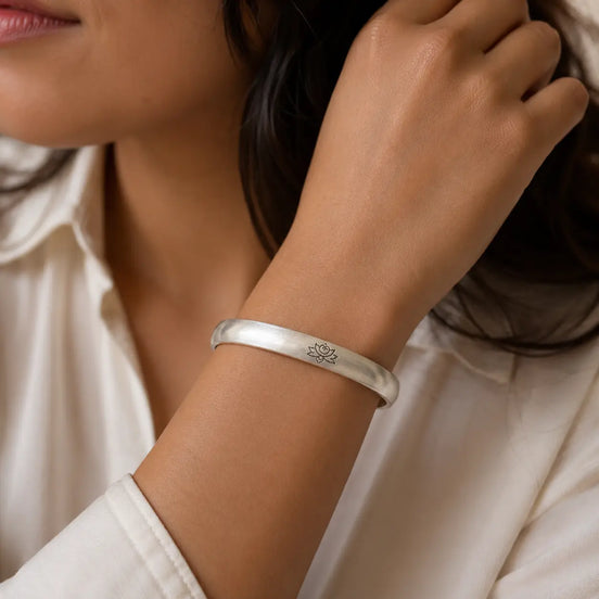 Lotus silver cuff worn on the wrist