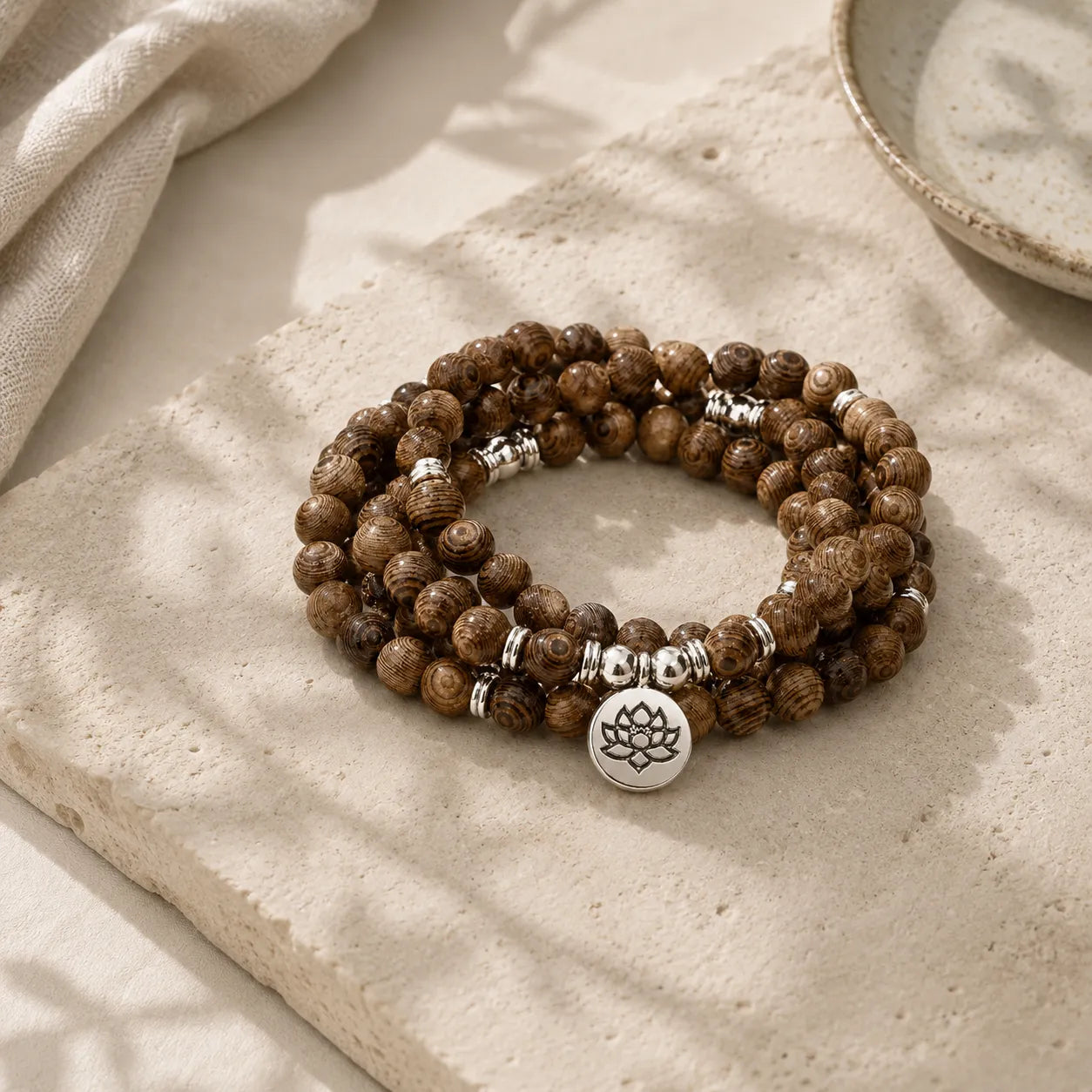 Lotus Wood Bead Mala Bracelet detail view with lotus