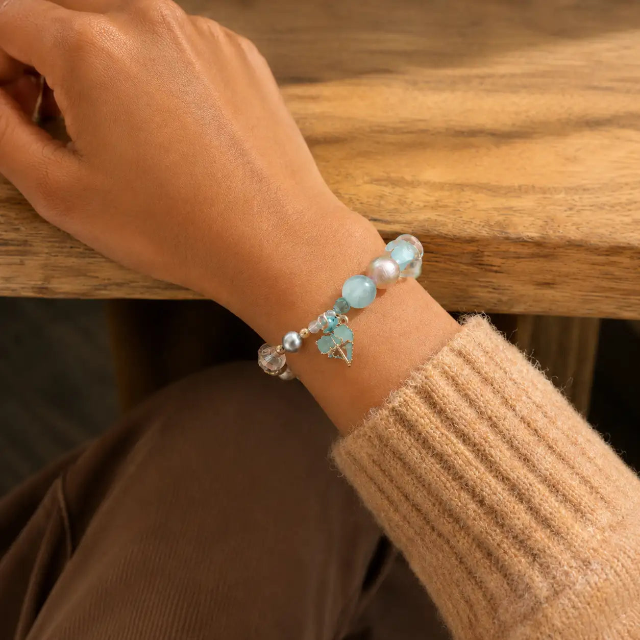 Mint green lock bead bracelet worn on the wrist