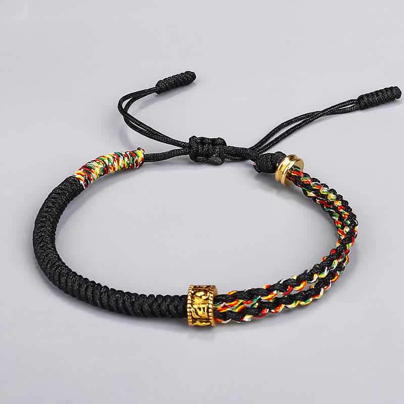 Om Mani Padme Hum Protection String Bracelet by TheFuMaster – black hand-woven cord with gold mantra charm for spiritual protection.
