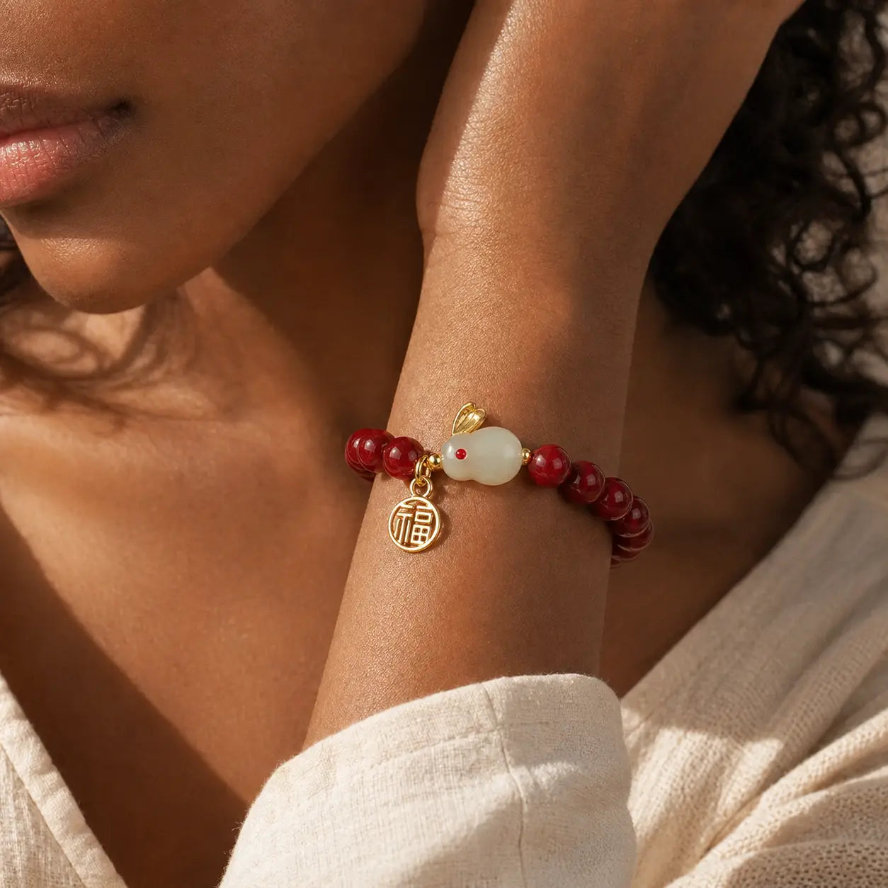 Quiet Fortune Red Stone Rabbit Fu Bracelet worn on wrist with red beads and gold charms