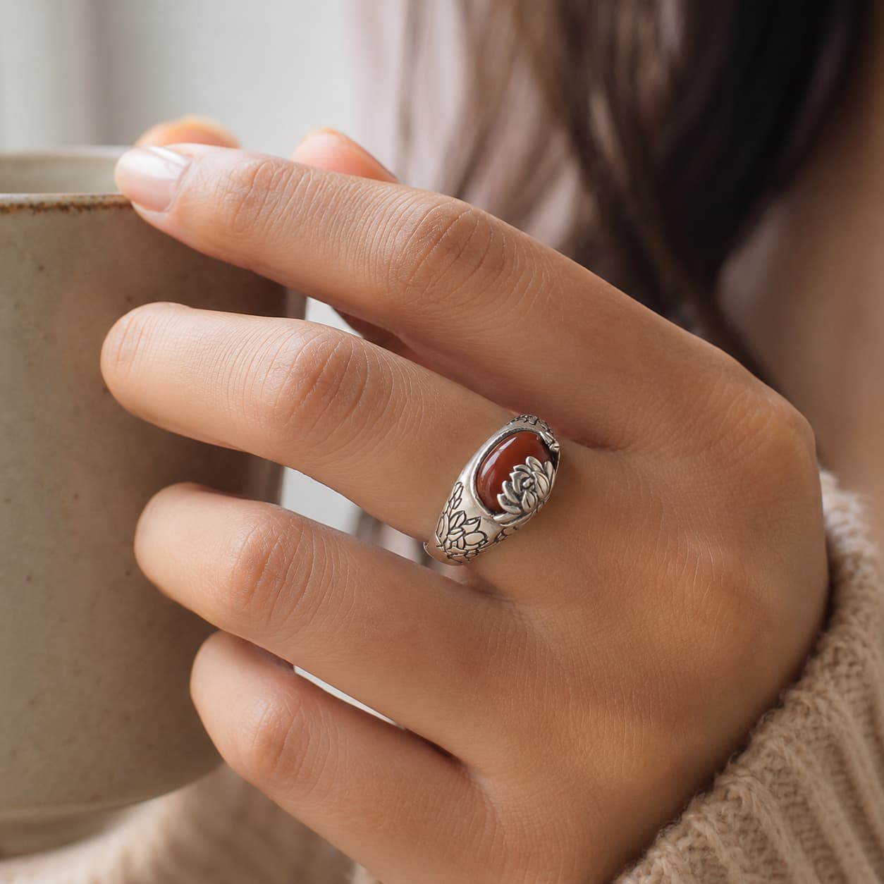 Close-up of Red Agate Lotus Ring with agate and lotus