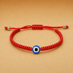 Red rope evil eye bracelet by TheFuMaster