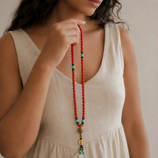 Red stone 108 mala worn on the wrist