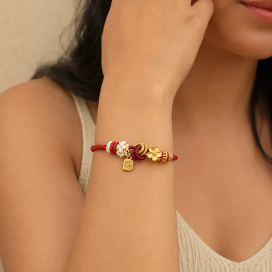 Red string Fu lock bracelet worn on the wrist