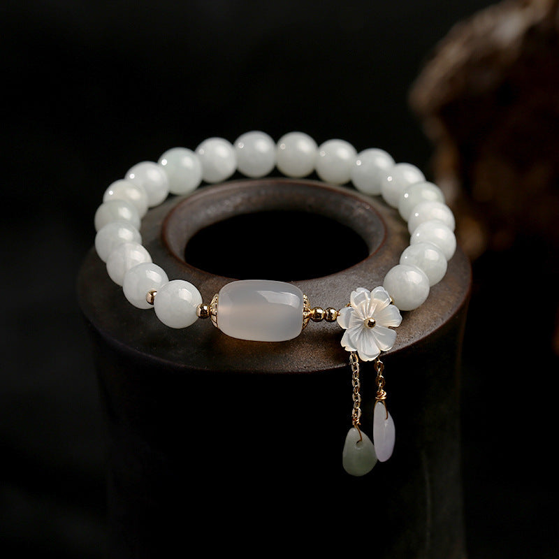 Side view of TheFuMaster Serene Blossom White Jade Bead Bracelet showing circular bead arrangement.
