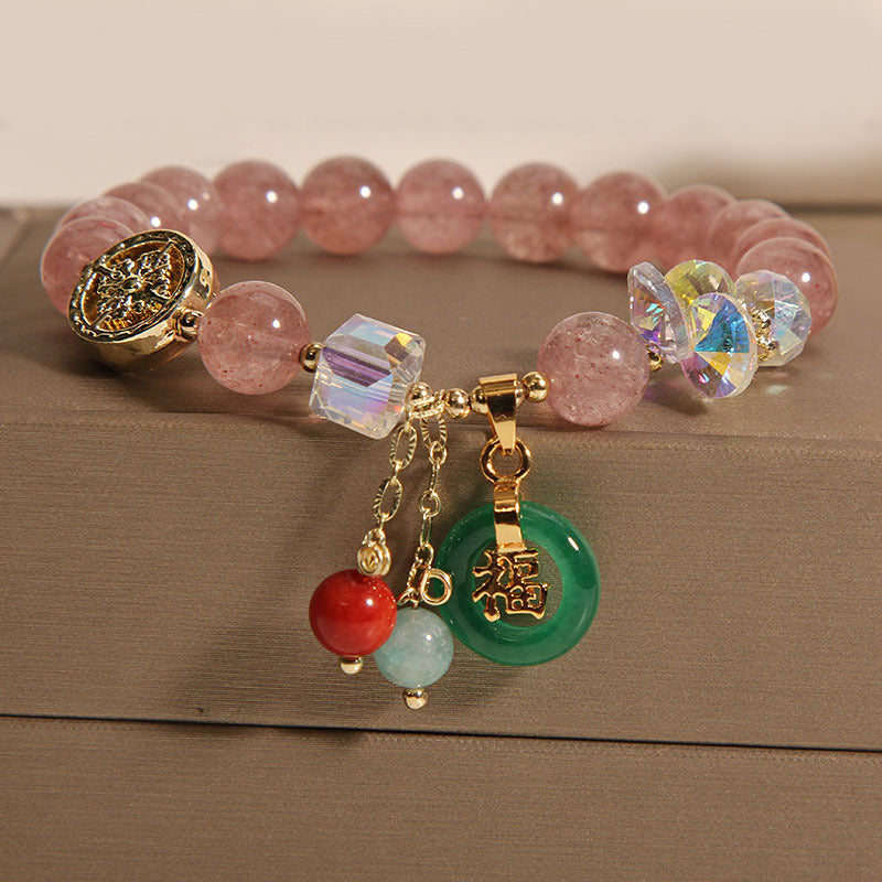 Strawberry Quartz Fu Charm Healing Bracelet on display with gold accents – TheFuMaster