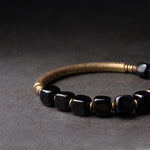Close-up of handcrafted Black Obsidian and Brass detail – TheFuMaster energy jewelry
