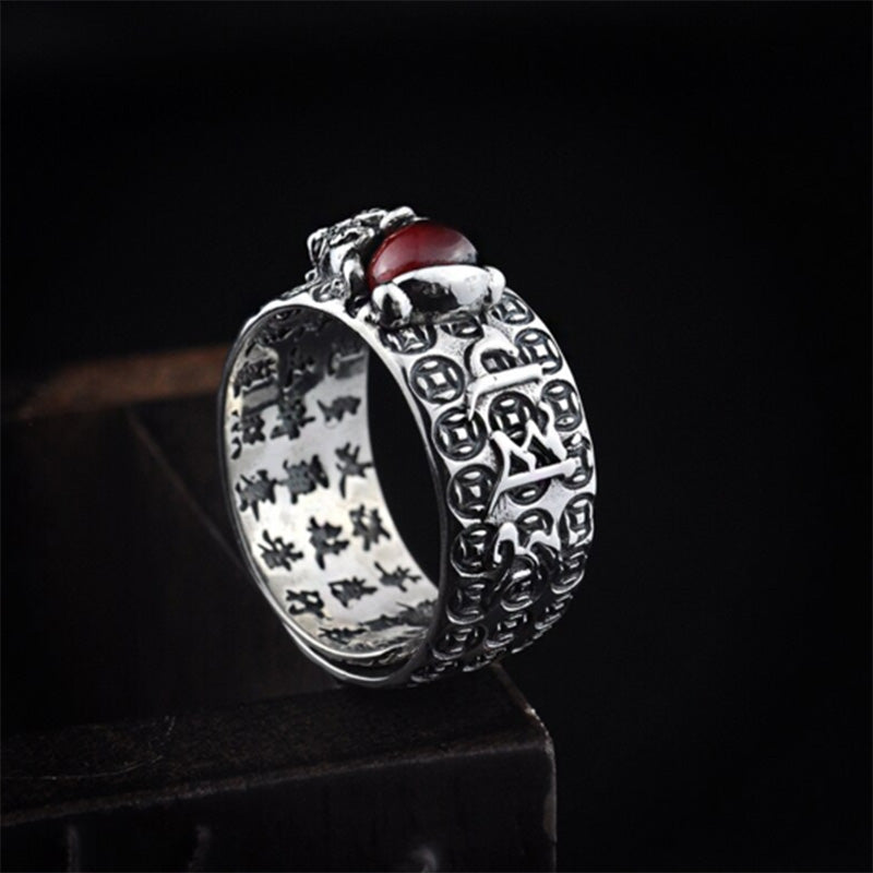 Elegant display of the Feng Shui Garnet PiXiu Wealth Ring against dark background