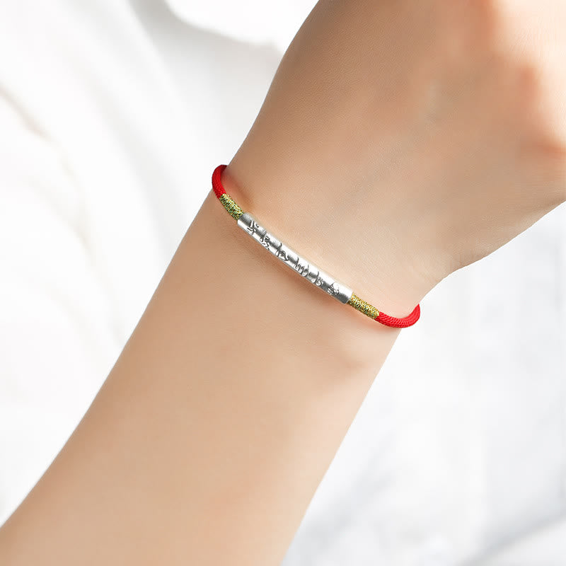 Model wearing sterling silver Tibetan mantra bracelet handmade with red cord