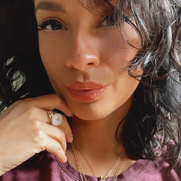 Lifestyle shot of the White Jade Plum Flower Leaf Ring worn casually, blending elegance with simplicity
