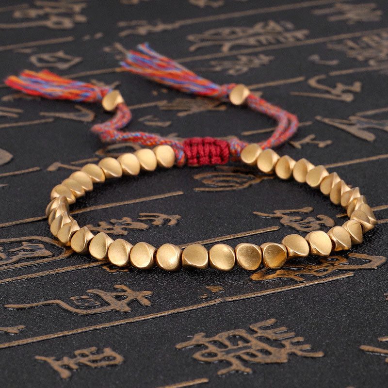 Full top view of Tibetan Copper Luck Bracelet with braided red cord, minimalist design for everyday wear.
