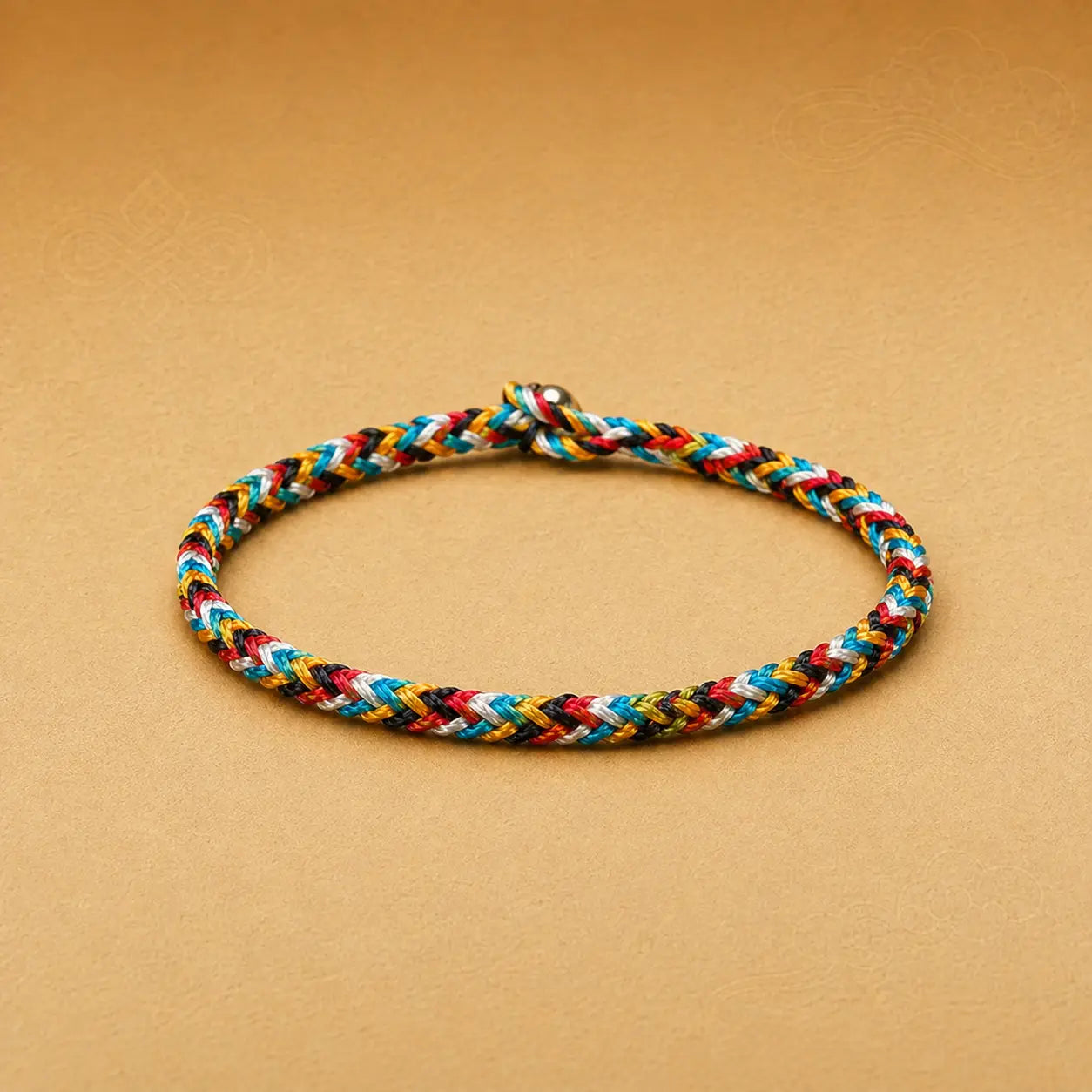 Multicolored braided bracelet on a beige background